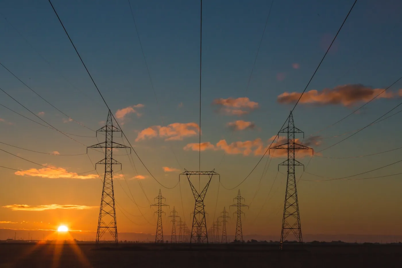 High-voltage transmission lines at sunset